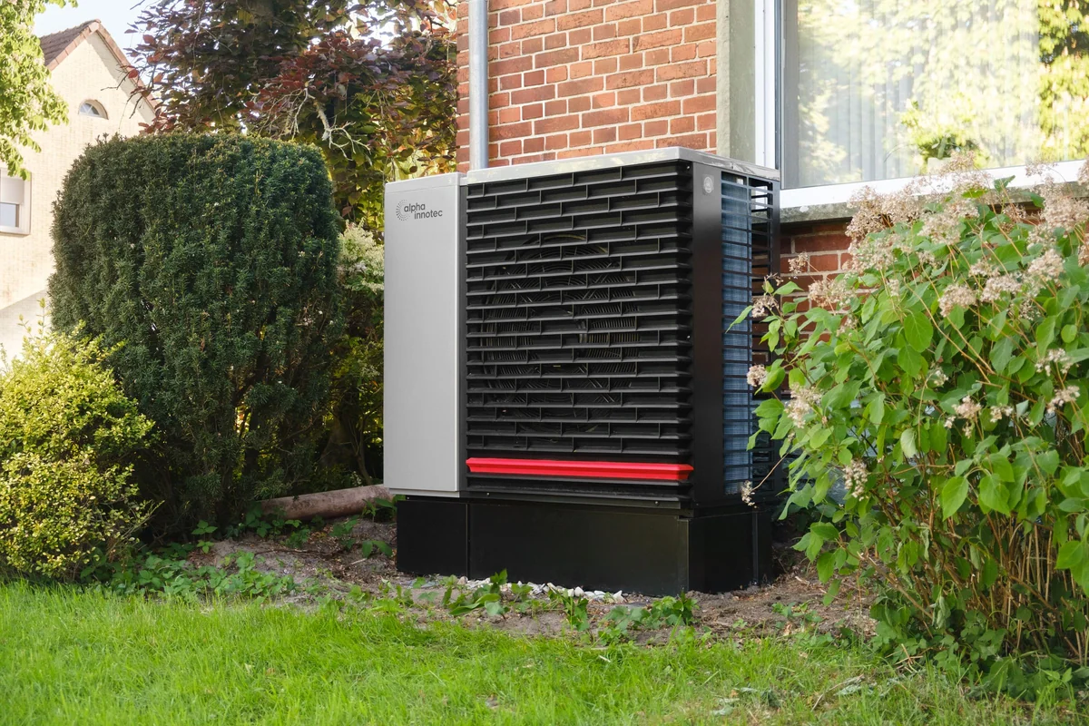 Outdoor heat pump installed beside a home