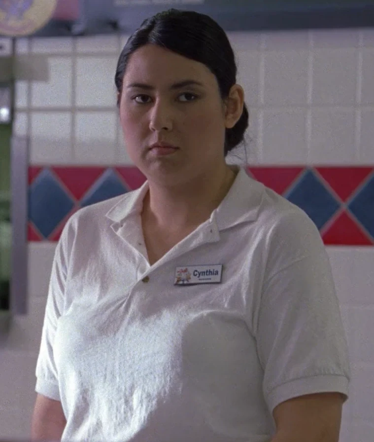 Cynthia welcoming customers in her Los Pollos Hermanos uniform